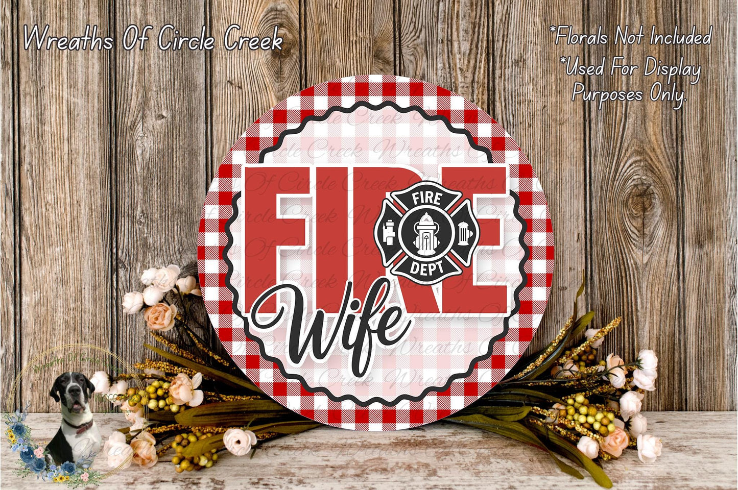 a round sign with the text "FIRE WIFE" in a red and white checkered pattern, surrounded by a floral arrangement and a wooden background.