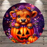A whimsical digital illustration featuring a brown cow with horns and a flower crown, peeking out from behind a carved pumpkin with a carved face, set against a purple and orange background with a bokeh effect.