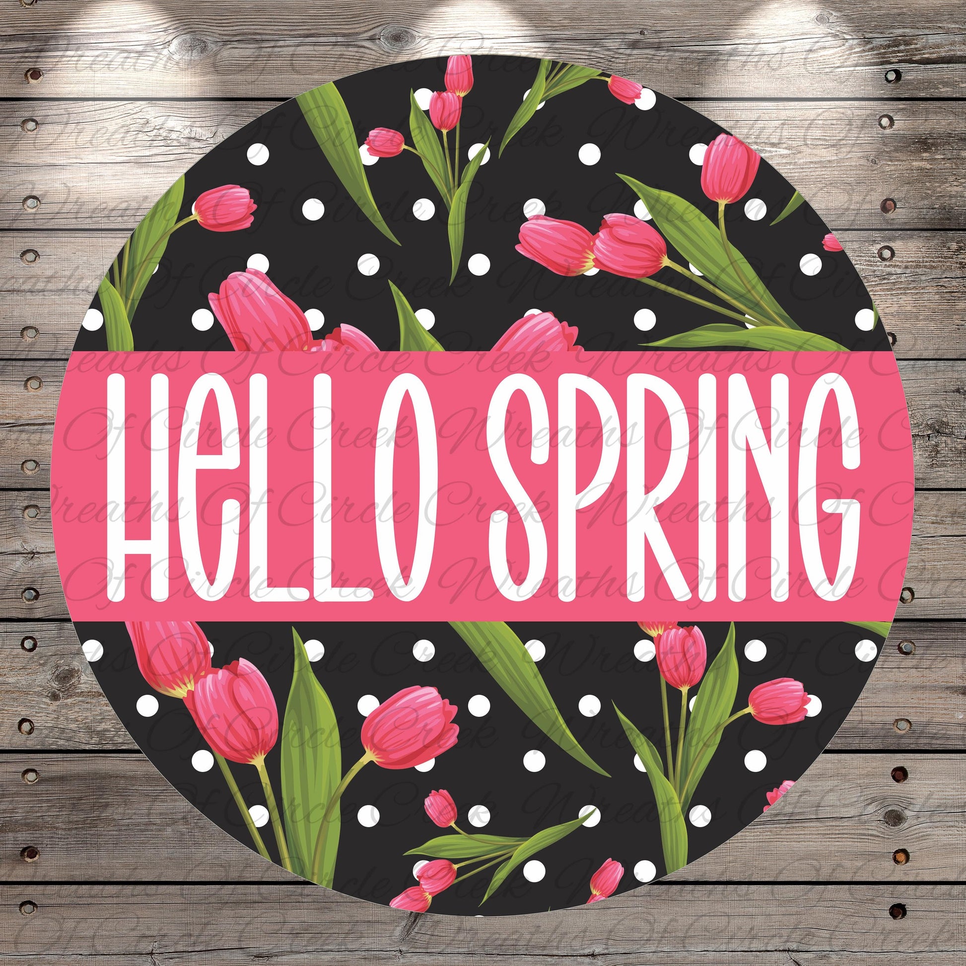 A circular design with a black background and pink flowers, along with the text "Hello Spring" written in white.