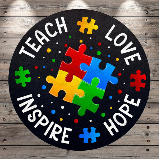 The image is a circular design with the words "TEACH LOVE INSPIRE HOPE" written around the edge. Inside the design, there are puzzle pieces in various colors, including red, yellow, green, blue, and red, arranged in a way that resembles a jigsaw puzzle.
