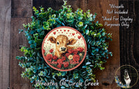 a wreath made of green foliage and red roses, with a cow's head and the text "Love Grows Here" displayed on it.