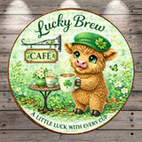 A round sign for a Lucky Brew Cafe featuring a cute, furry animal holding a mug with a clover on it, surrounded by flowers and greenery.