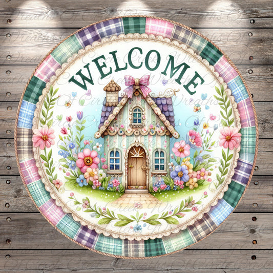 A decorative plate with a charming illustration of a small house surrounded by flowers and greenery, with the word "WELCOME" prominently displayed.