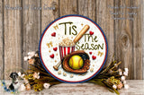 a decorative plate with a baseball theme, surrounded by flowers and a baseball glove. The plate has the text "Tis the Season" written on it, and there is a baseball bat and popcorn depicted on the plate.