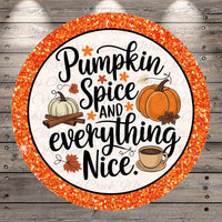 a circular design with a glittery border, surrounded by a wooden background. The design includes a pumpkin, spices, and a cup of coffee, along with the text "Pumpkin Spice and everything Nice."