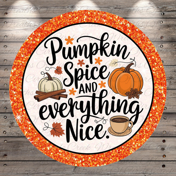 a circular design with a glittery border, surrounded by a wooden background. The design includes a pumpkin, spices, and a cup of coffee, along with the text "Pumpkin Spice and everything Nice."