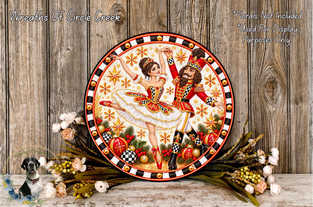 a decorative plate with a painting of a ballerina and a nutcracker figure, surrounded by a floral arrangement and a wooden background.