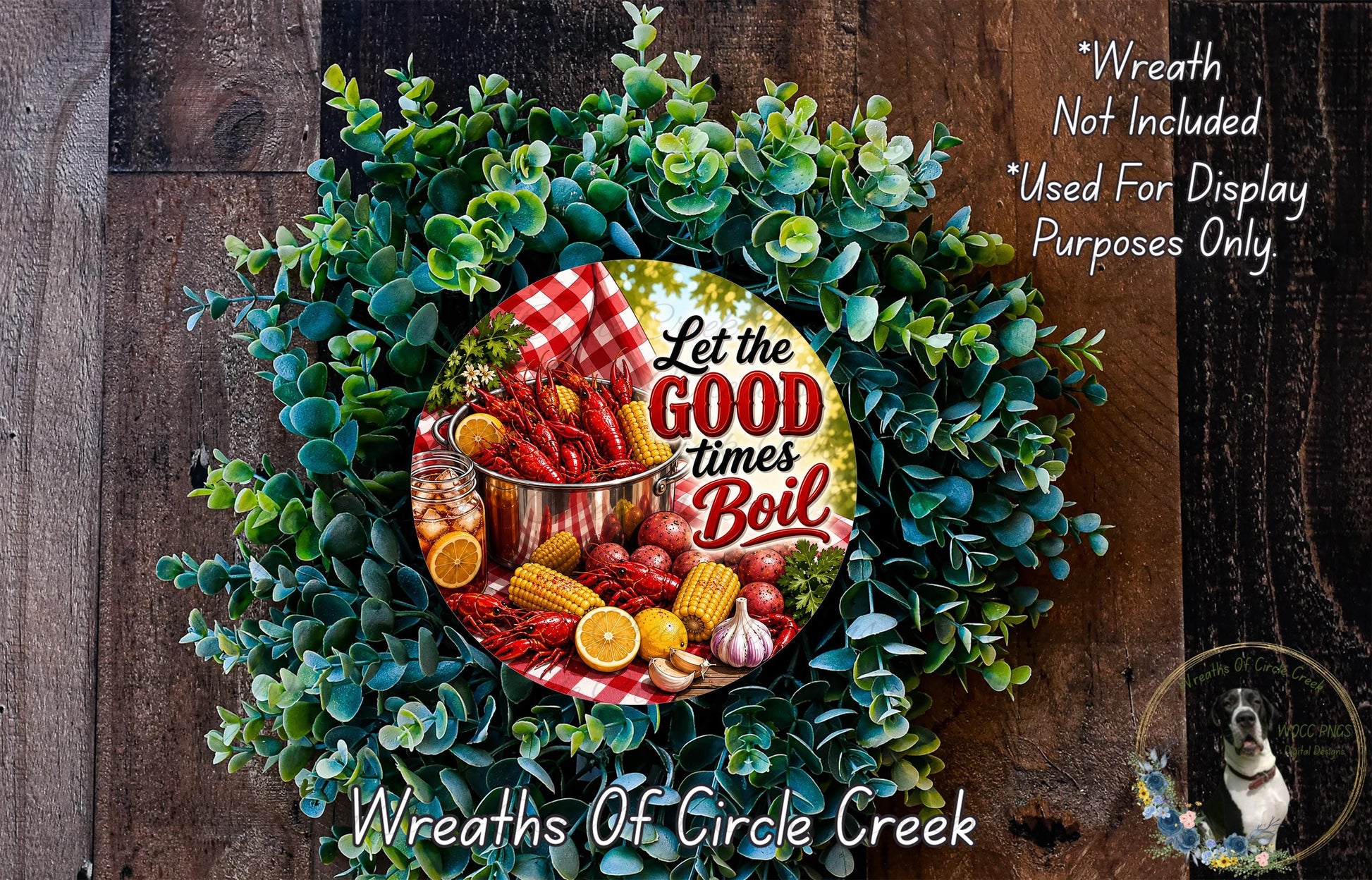 A wreath made of green leaves and various food items, including a large pot of food, is displayed on a wooden surface.
