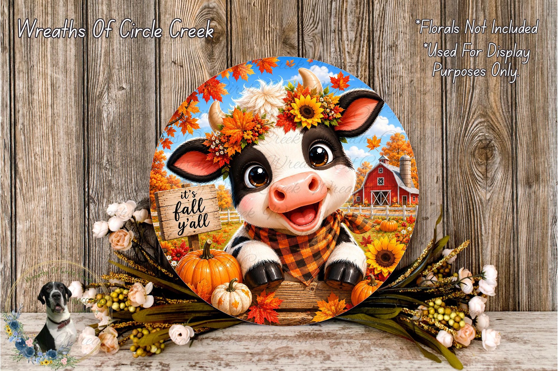 A decorative wreath featuring a cow surrounded by fall elements such as pumpkins, sunflowers, and a sign that says "It's fall y'all".