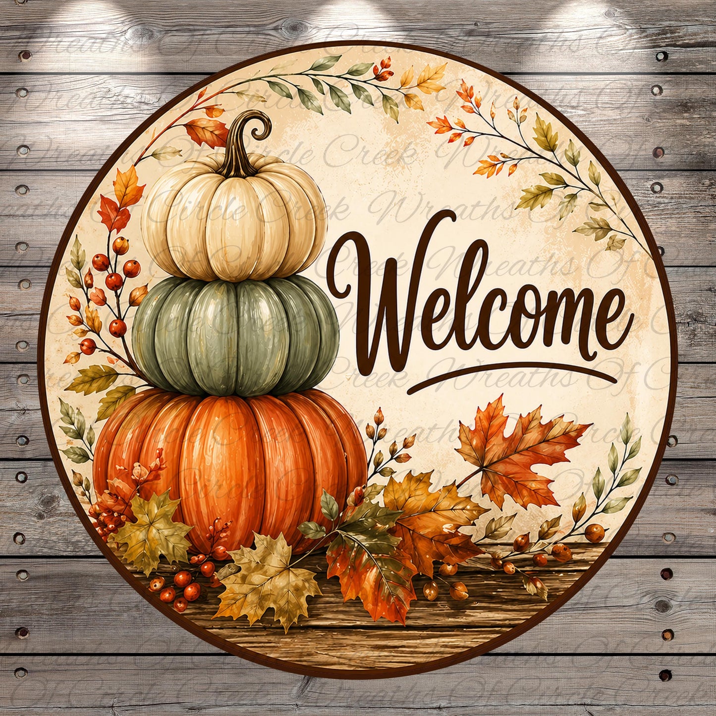 A circular welcome sign with a stack of three pumpkins, autumn leaves, and berries, surrounded by a wreath of leaves and the word "Welcome" written on a wooden background.