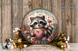 A decorative wreath featuring a raccoon holding a heart-shaped ornament, surrounded by flowers and greenery.