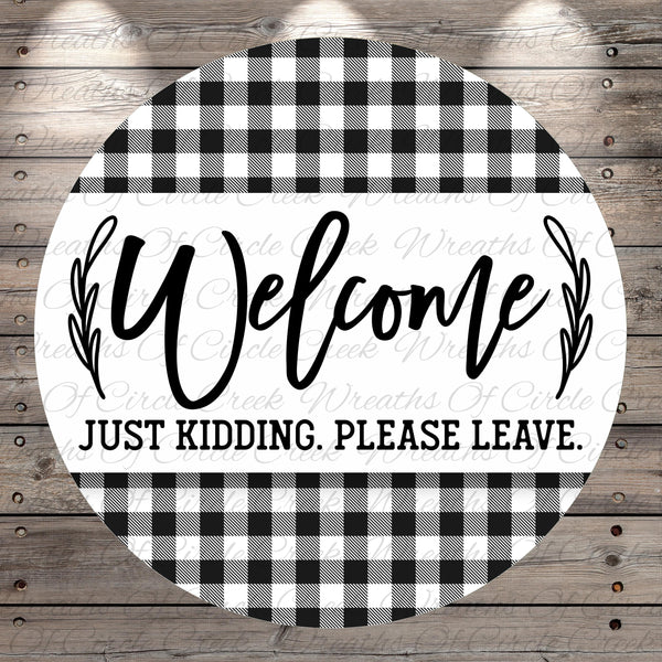 A circular sign with a black and white checkered pattern and the text "Welcome Just Kidding. Please Leave."