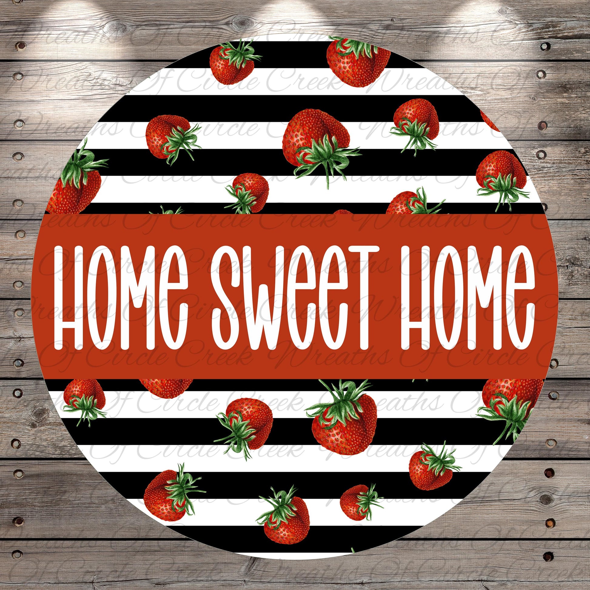 a circular design with a repeating pattern of red strawberries against a black and white striped background. The text "HOME SWEET HOME" is prominently displayed in the center of the design.