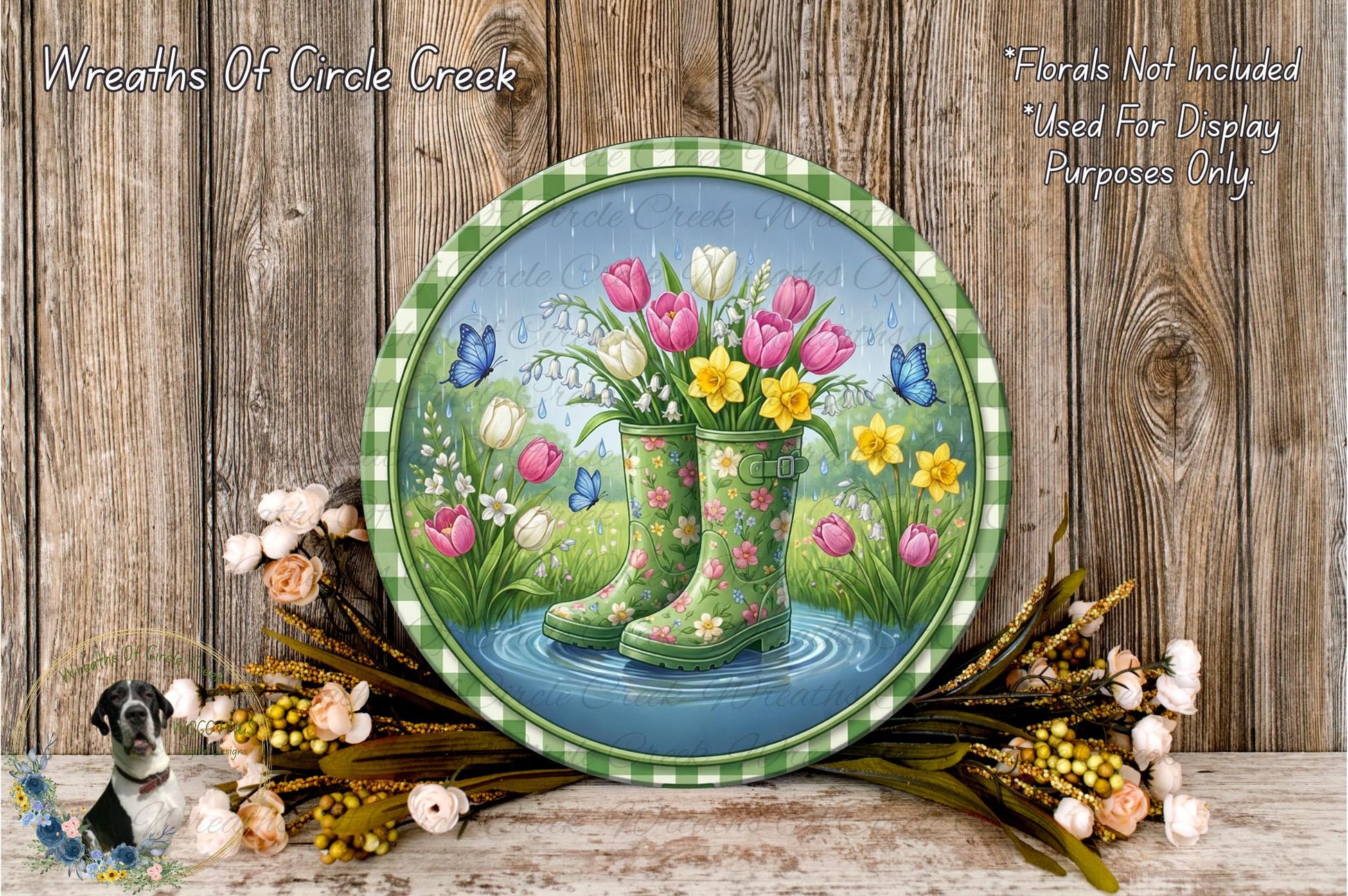 A round, green-rimmed plate with a painting of a pair of rain boots filled with colorful flowers, including tulips, daffodils, and lilies, set against a backdrop of a pond and lush greenery.