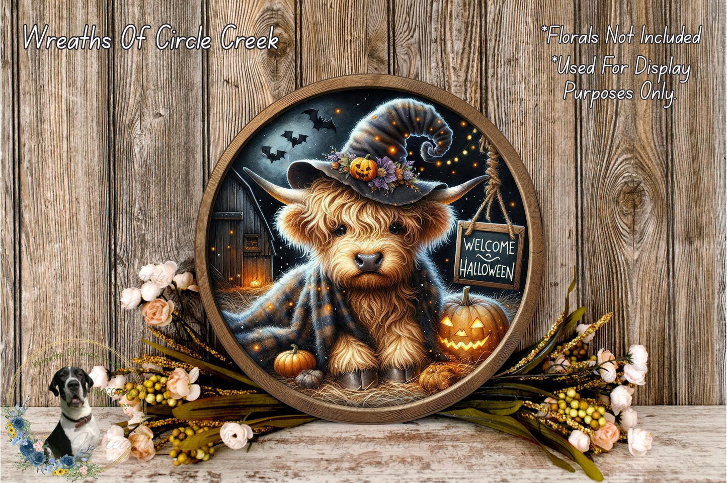 A round wooden frame with a painting of a small dog wearing a witch's hat, surrounded by Halloween decorations such as pumpkins, flowers, and a "Welcome to Halloween" sign.
