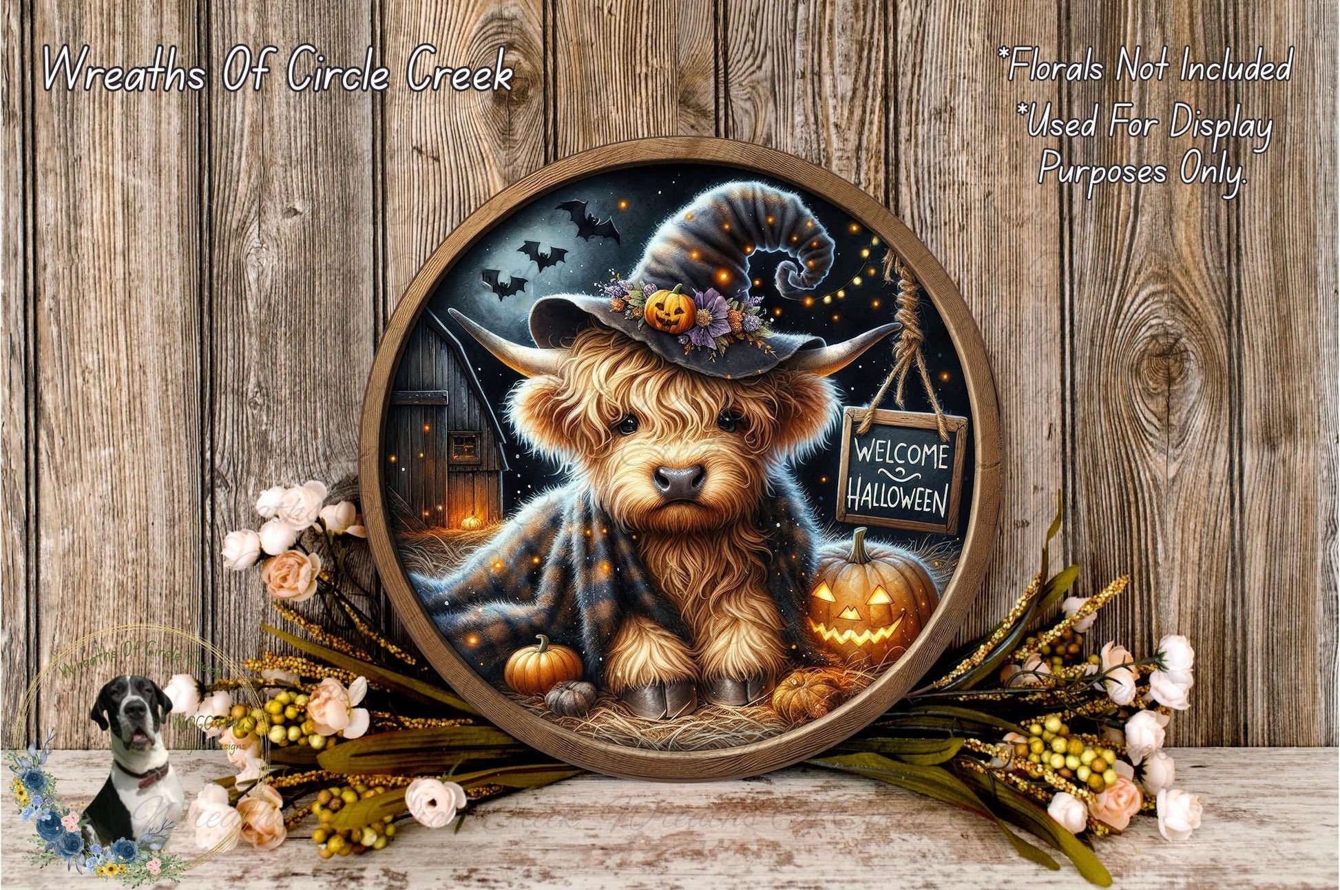 A round wooden frame with a painting of a small dog wearing a witch's hat, surrounded by Halloween decorations such as pumpkins, flowers, and a "Welcome to Halloween" sign.