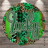 a circular design with a bold, stylized word "Lucky" in the center. The background of the design is a mix of green and brown, with various patterns and textures, including leopard print and glitter.