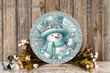 A snowman with a blue hat and scarf, surrounded by snowflakes, pine cones, and flowers, is displayed on a wooden surface.