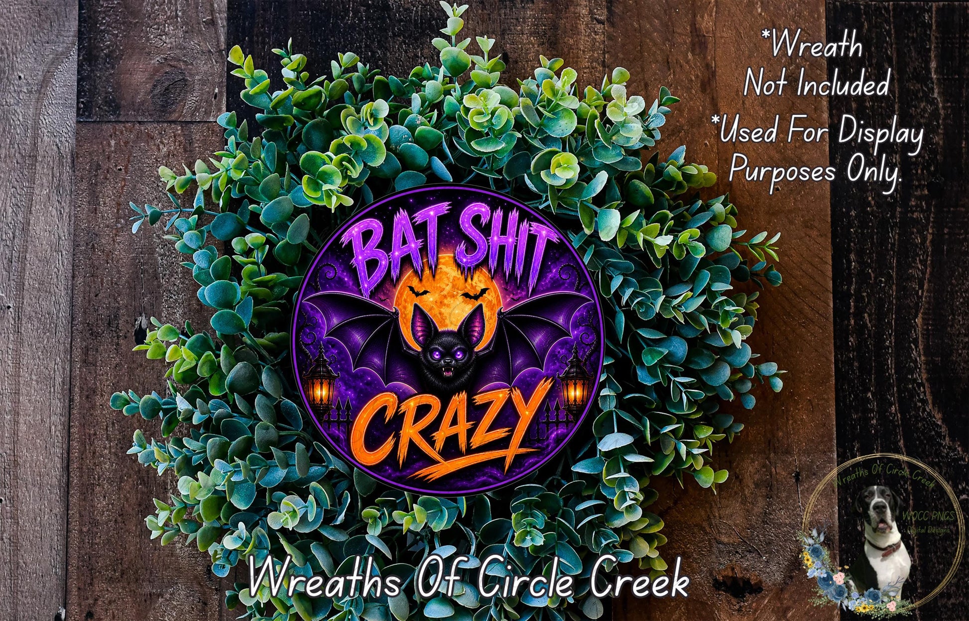a wreath with a bat and the text "Bat Shit Crazy" on it, surrounded by greenery.