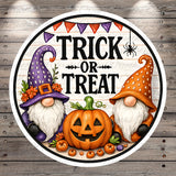 a Halloween-themed graphic with two gnomes, a carved pumpkin, and a banner that reads "TRICK OR TREAT".