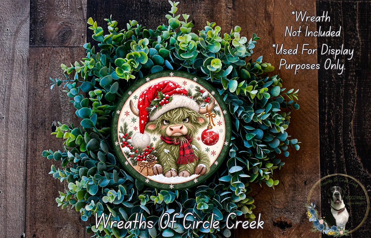 A wreath featuring a cow wearing a Santa hat, surrounded by greenery, with a text overlay that reads "Wreath Not Included * Used For Display Purposes Only" and "Wreaths of Circle Creek".