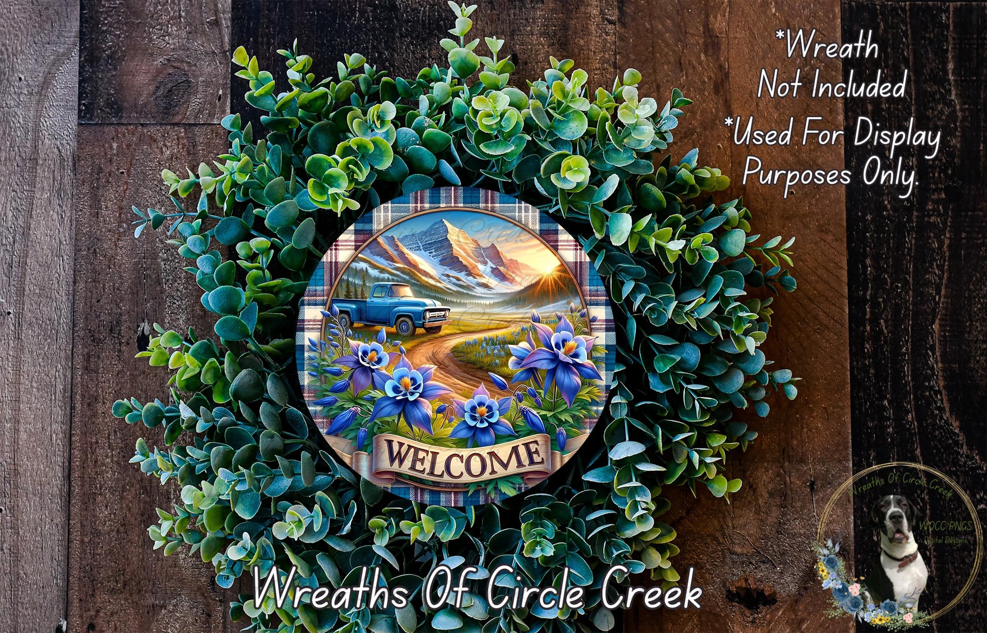 a wreath with a welcome sign, surrounded by greenery and flowers, with a scenic mountain landscape in the background.