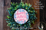 A wreath made of green leaves and flowers, with a pink circular sign that says "Happy Mother's Day" in the center.