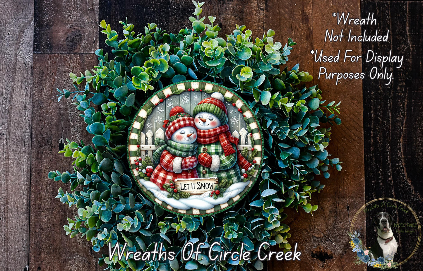 A wreath with a snowman and a sign that says "Let it snow" is displayed on a wooden surface.