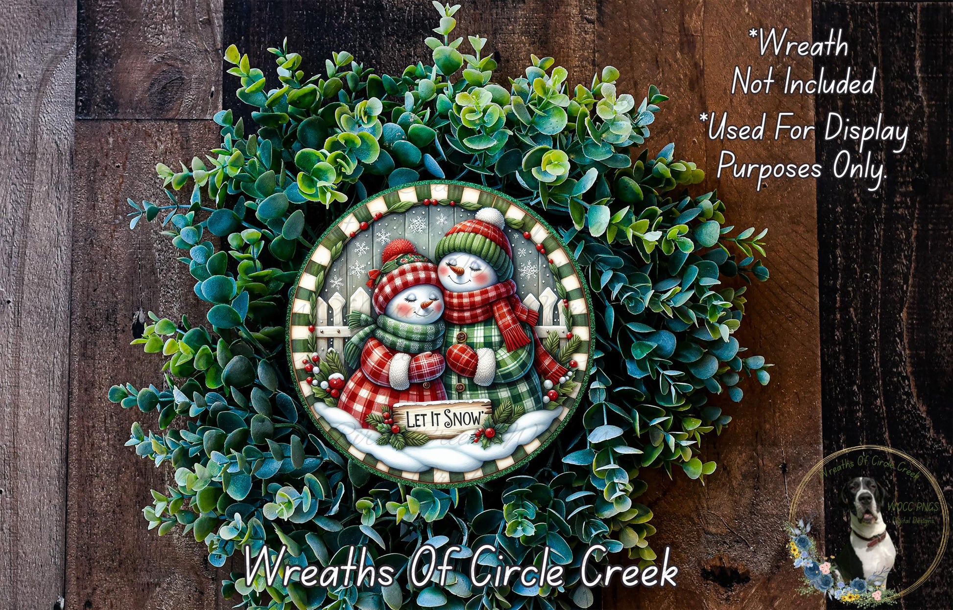A wreath with a snowman and a sign that says "Let it snow" is displayed on a wooden surface.