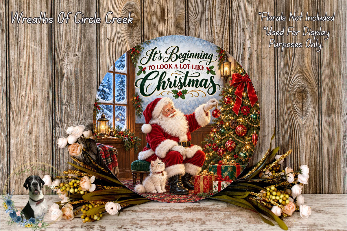 A circular wreath with a Santa Claus figure and a Christmas tree, surrounded by flowers and greenery, with the text "It's Beginning to look like Christmas" displayed on the wreath.