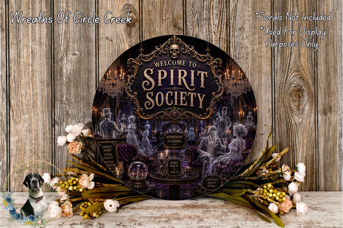 a large circular sign with the text "Welcome to Spirit Society" displayed prominently in the center. The sign is surrounded by a decorative arrangement of flowers and foliage, creating a festive and welcoming atmosphere.