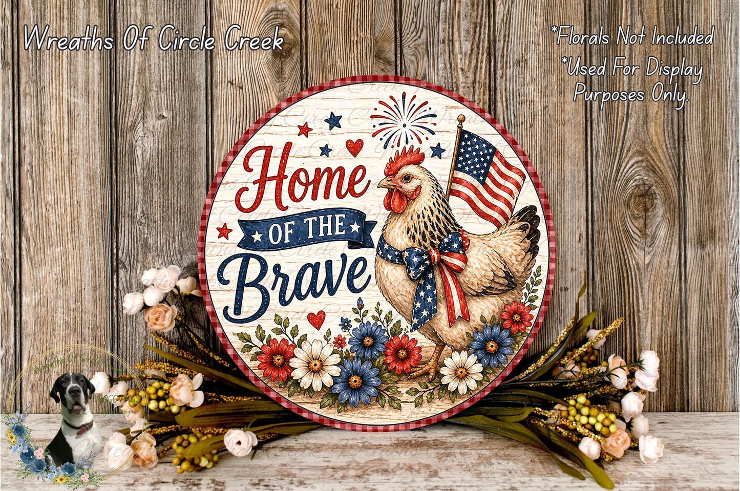 a decorative sign with a rooster and flowers, along with the text "Home of the Brave" and an American flag. The sign is placed on a wooden surface, surrounded by flowers.