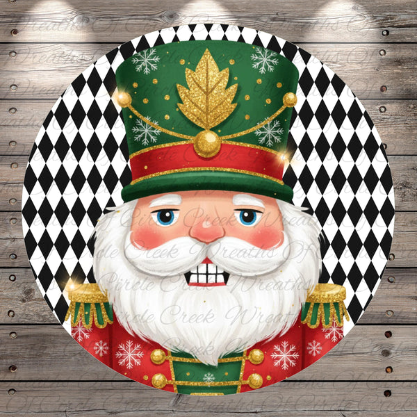 A close-up of a smiling nutcracker figure wearing a green hat with gold accents and red and gold epaulettes, set against a black and white diamond patterned background.
