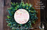 A wreath made of green leaves and colorful donuts, with the text "Merry Christmas" displayed on it.