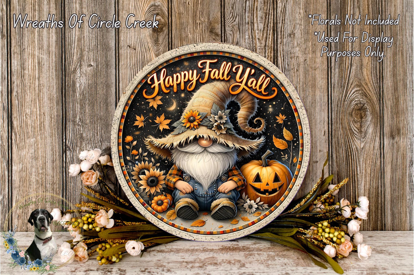 A decorative wreath featuring a gnome wearing a hat and holding a pumpkin, surrounded by autumn flowers and leaves. The text on the wreath reads "Happy Fall Yell".
