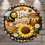 A decorative cake featuring a bee, honeycomb, sunflower, and other bee-themed elements, along with the text "Bee Happy".