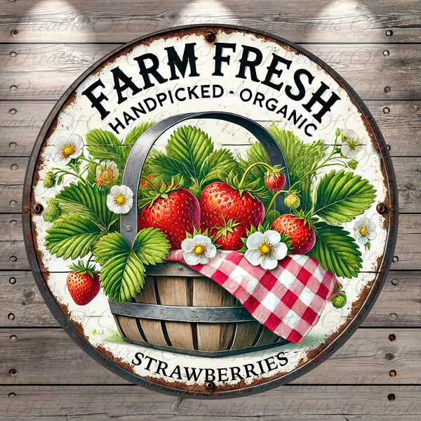 A vintage-style sign with a basket of fresh strawberries and a red and white checkered cloth, surrounded by green leaves.