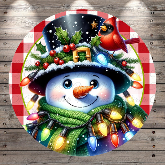 A cheerful snowman wearing a black top hat with a red cardinal perched on it, surrounded by colorful Christmas lights and a green scarf.