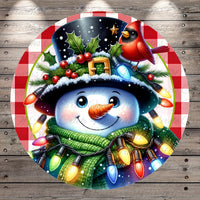 A cheerful snowman wearing a black top hat with a red cardinal perched on it, surrounded by colorful Christmas lights and a green scarf.