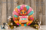 A decorative Thanksgiving wreath with a turkey holding a sign that says "GOBBLE TIL YOU WOBBLE!" surrounded by fall foliage and flowers.