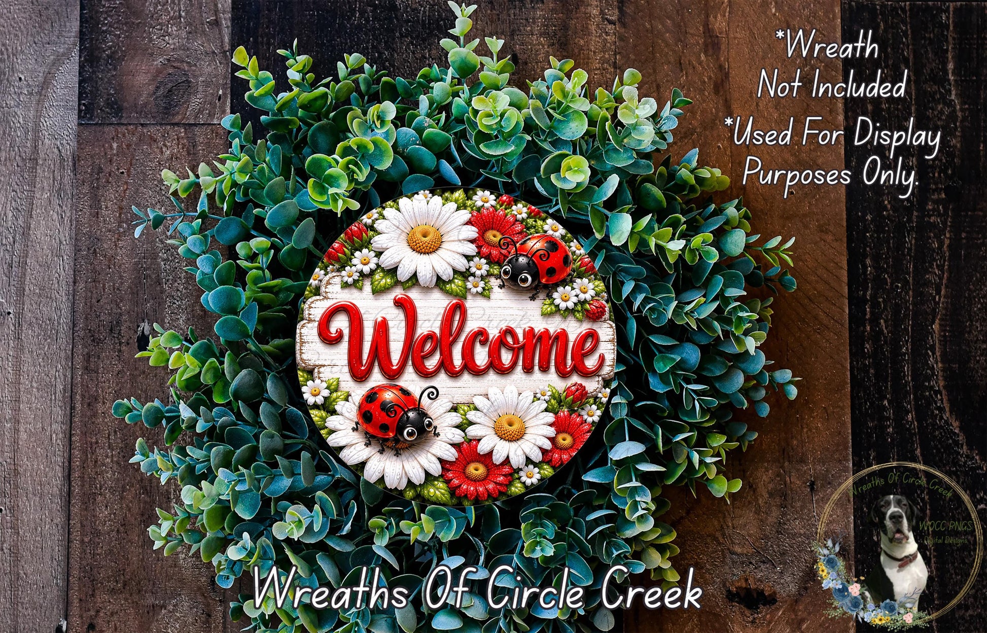 a wreath with a welcome sign in the center, surrounded by various green leaves and flowers. The wreath is displayed on a wooden surface, and there is a small dog in the bottom right corner of the image.