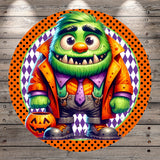 A cartoon monster with a green body, orange jacket, and purple pants is holding a carved pumpkin, standing against a wooden background with a polka dot border.