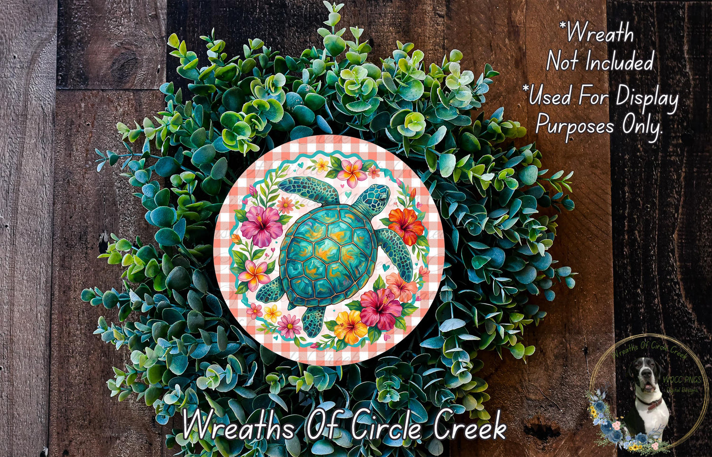 A wreath made of various green plants and flowers, with a large circular design featuring a turtle surrounded by colorful flowers.