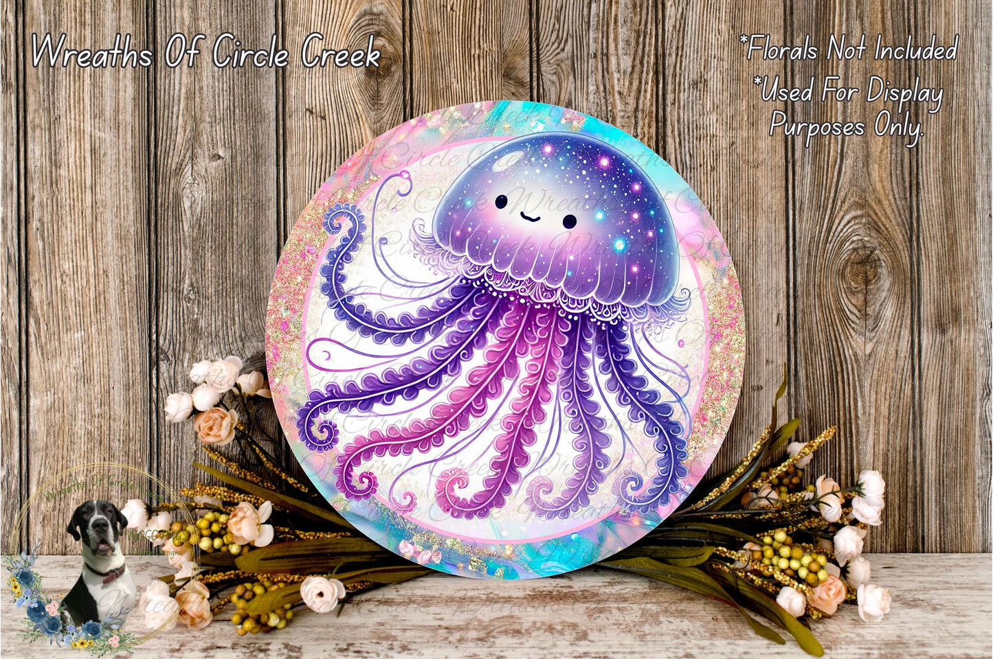 a round, colorful wreath with a purple jellyfish design on it, placed on a wooden surface. The wreath is surrounded by flowers and greenery, creating a whimsical and nature-inspired scene.