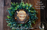 a Christmas wreath with a decorative mouse design, surrounded by greenery. The wreath is displayed on a wooden surface, and there is a small dog in the bottom right corner of the image.