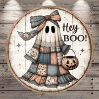 A circular Halloween-themed decoration featuring a ghost with a bow, holding a carved pumpkin and the text "Hey Boo!"