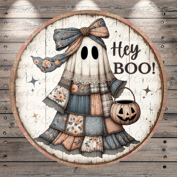 A circular Halloween-themed decoration featuring a ghost with a bow, holding a carved pumpkin and the text "Hey Boo!"