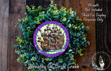a wreath with a purple border and a ship illustration in the center, surrounded by green foliage.