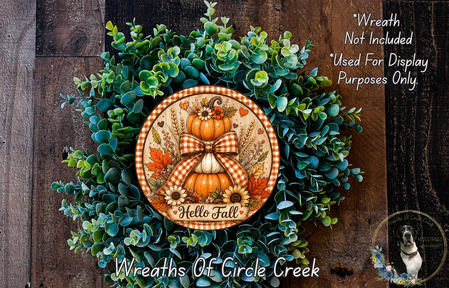 a wreath made of various green plants and a decorative orange and white sign that says "Hello Fall". The sign is surrounded by a lush, colorful wreath.