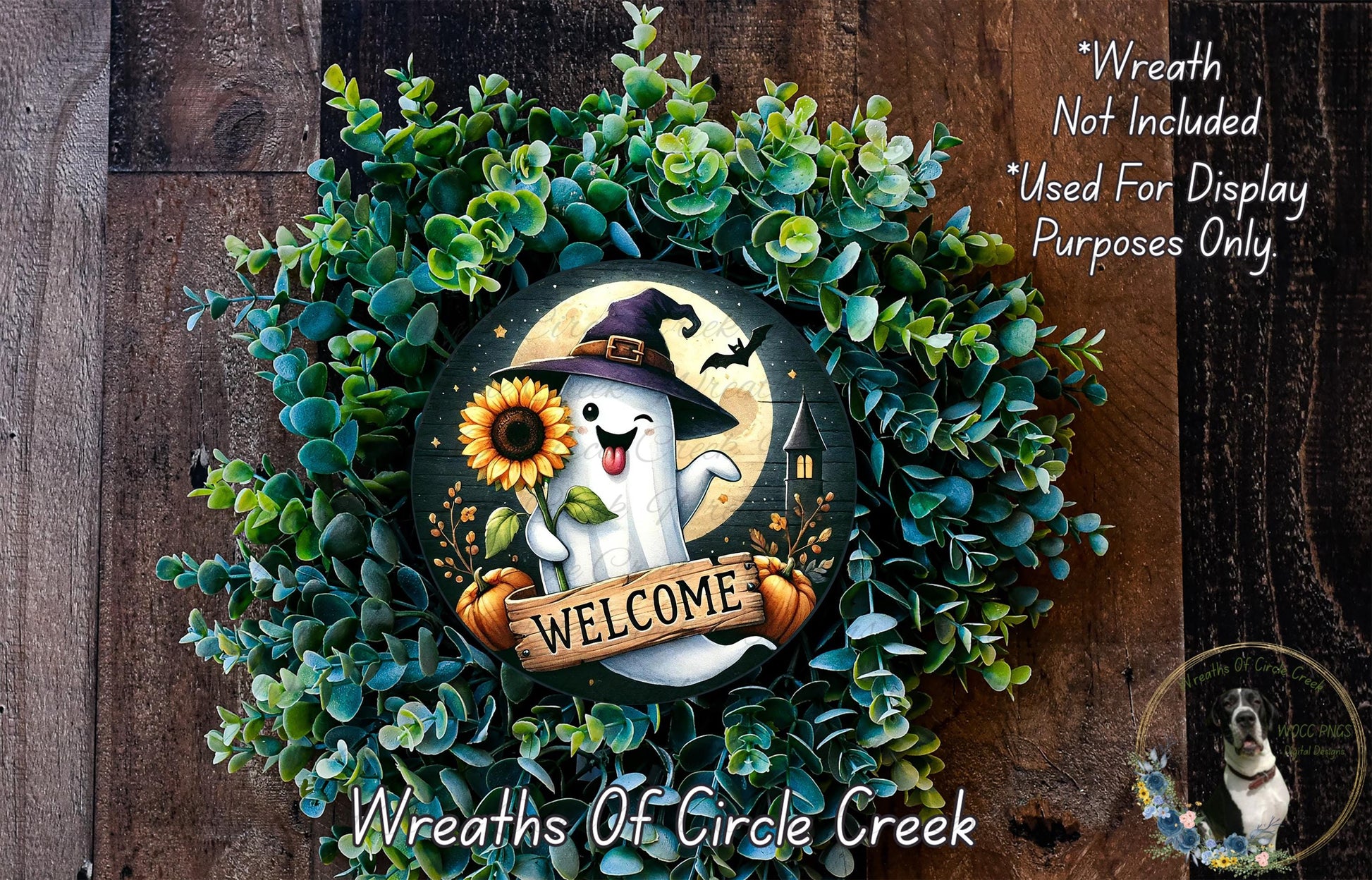 A wreath made of green foliage and featuring a ghost wearing a witch's hat, holding a sunflower and a banner that says "Welcome".